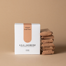 Packaging of Lila Jasmine milk support lactation bars, stack of 6 on a beige background