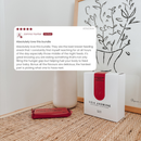 Breastfeeding Support Snacks sits on a a bedside table. A large customer review card is superimposed on the left side of the image.