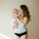 Carry Main Squeeze Pregnancy & Postpartum Support Belt, postpartum mum wearing holding newborn