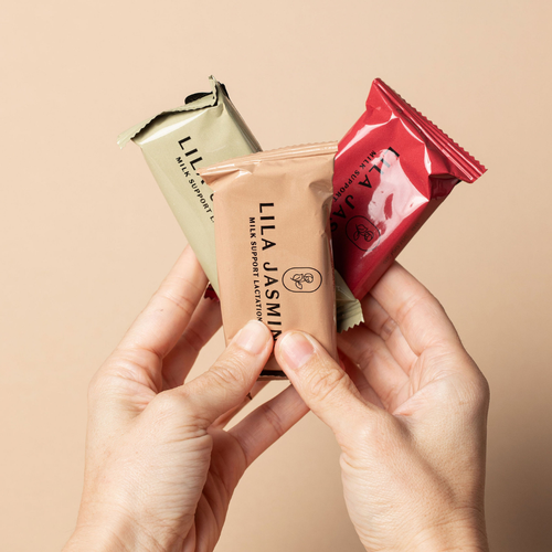 Three Lila Jasmine milk support lactation bars held by hands against a beige background