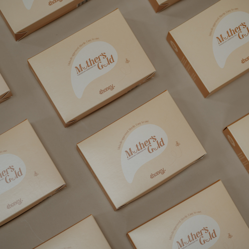 Multiple 'Mother's Gold Colostrum Collection Kit' boxes arranged on a flat surface