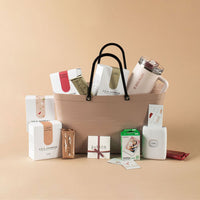 Prize Pack including Stanley Cup, Hinza Bag, Sophie Voucher, Instax Printer & Film as well as Lila Jasmine Lactation Bars on a beige background